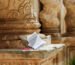 Un block notes e una penna sulla base della colonna tortile di una chiesa barocca di Palazzolo Acreide